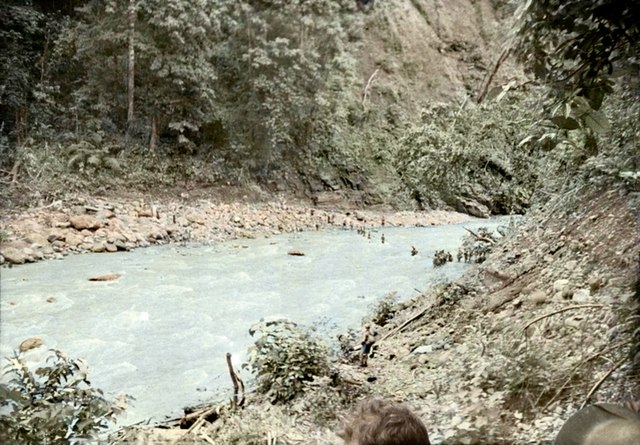 Late January 1942. Australian soldiers (right centre) retreating from Rabaul cross the Warangoi/Adler River in the Bainings Mountains, on the eastern 