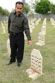 Bakhtiar Awmar Points to Grave Where His Father, Mother, and Sister Are Buried - Victims of 1988 Chemical Attack - Halabja - Kurdistan - Iraq.jpg