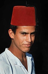 Young Bedouin man wearing a North African version of the fez. Bedouin man with Fez.jpg