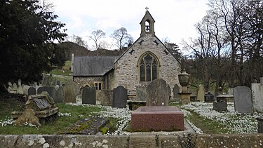 Llantysilio Church, 2015. In foreground is the grave of Charles Beyer, who died in 1876. Beyer Grave and Llantysilio Church,Denbighshire,N Wales.jpg