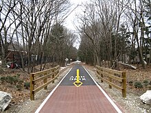 The Bruce Freeman Rail Trail in South Chelmsford, on the line once occupied by the Framingham and Lowell Railroad Bruce Freeman Rail Trail, South Chelmsford MA.jpg