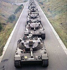 Several early Leopard tanks (0-series prototypes) preparing for parade duty, distinguished by the centrally-mounted IR/white searchlight and rectangular loader's hatch. Bundesarchiv B 145 Bild-F027415-0001, Kampfpanzer Leopard I.jpg