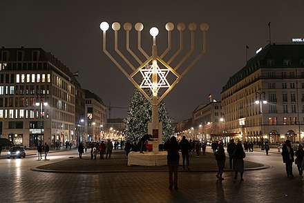 A large public menorah, with a Christmas tree visible in the background, at Pariser Platz on December 11, 2020