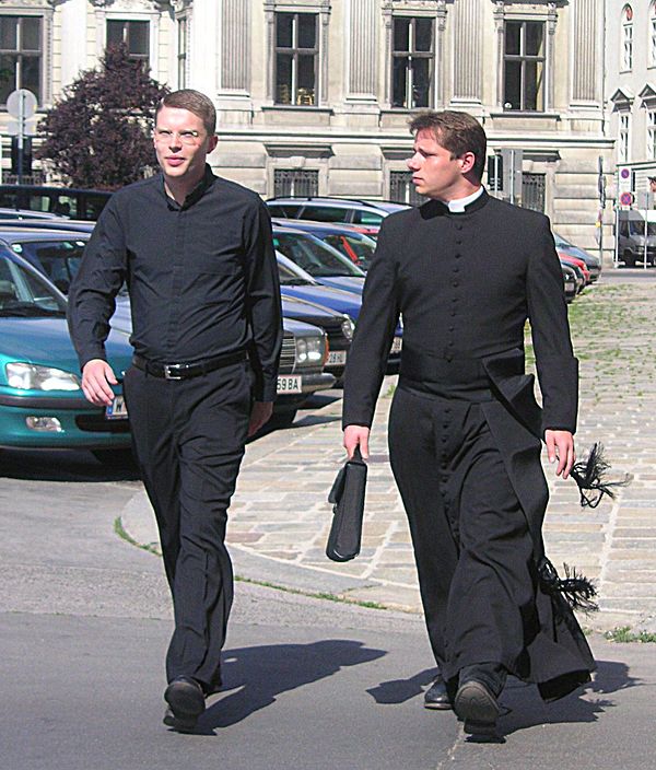 On the right, an example of the full collared shirt and cassock; on the left, a clerical shirt that could have a tab collar inserted.