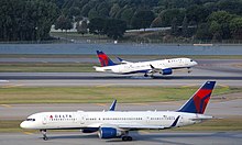 Delta A220-300 landing at MSP with a Delta 757-200 taxiing in the foreground.