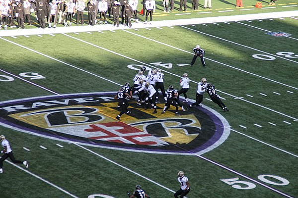 Saints quarterback Brees (#9) drops back as Lewis (#52) blitzes