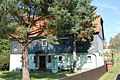 Residential house (surrounding lumber) and lumber house in front of the house