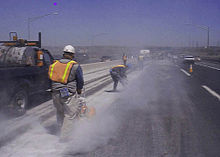 Highway road workers using concrete saws and generating dust. Highway work dust.jpg