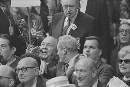 Illinois delegates (including then Mayor Richard J. Daley and his son future mayor Richard M. Daley) react to Senator Abraham Ribicoff's criticism of the Chicago Police. Reports differ as to whether the elder Daley shouted, "You faker!" or, "Fuck you, you Jew son of a bitch."[62][63]