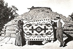 Trader John Bradford Moore and a Navajo rug, 1911. J.-B.-Moore-Crystal-Trading-Post-with-Navajo-Rug.jpg