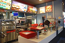 Standardisation, sometimes called the McDonald's approach, helps to reduce perceived risk because consumers can rely on a known product and quality. Mc Donalds Winterthur-Gruze Ladentheke.jpg