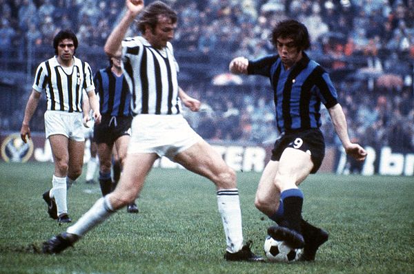 Roberto Boninsegna tackled by Francesco Morini during a derby d'Italia in 1974.