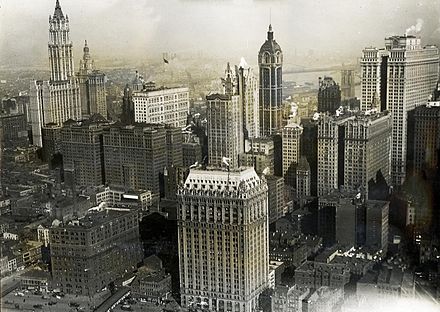 Aerial view of Lower Manhattan in 1919 looking east; the Singer Tower is at center right