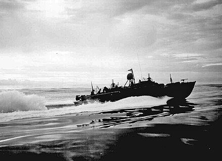 An 80-foot (24 m) Elco PT boat with original Mark 18 torpedo tubes on patrol off the coast of New Guinea, 1943