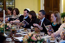 President Barack Obama and guests read from the Maxwell House Haggadah at the 2010 White House Passover Seder Passover Seder Dinner at the White House 2010.jpg