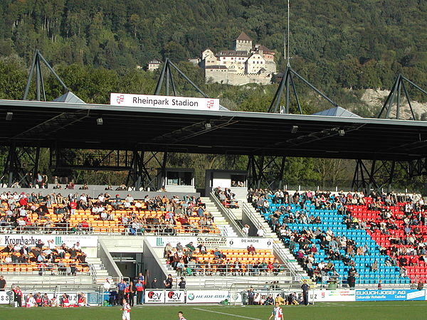 Main stand of the Rheinpark Stadion with Vaduz Castle in the background.