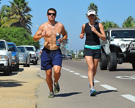 A man and woman in running shorts