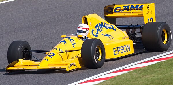 Nakajima driving a Lotus 101, originally used during the 1989 Formula One season, at the 2011 Japanese Grand Prix.