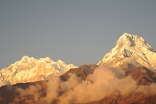 South face of Annapurna South: Annapurna I (8,091 m) visible as the rounded top,left of center.