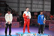 Deutsch: Tischtennis bei den Olympischen Jugend-Sommerspielen 2018: Tag 4, 10. Oktober 2018, Jungen-Einzel, Siegerehrung - Gold: Wang Chuqin (CHN), Silber: Tomokazu Harimoto (JPN), Bronze: Kanak Jha (USA); Medaillen überreicht durch IOC-Mitglied William Frederick Blick (UGA), Maskottchen überreicht durch ITTF-Präsident Thomas Weickert (GER) English: Fencing at the 2018 Summer Youth Olympics at 10 October 2018 –Boys' single medail ceremony – Gold: Wang Chuqin (CHN), Silber: Tomokazu Harimoto (JPN), Bronze: Kanak Jha (USA)); Medal presenter: IOC member William Frederick Blick (UGA), Mascot presenter: ITTF President Thomas Weickert (GER)