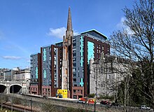 Spire in 2023, emerging from the completed "The Point" development. The Point flats and Triple Kirks spire (geograph 7446788).jpg