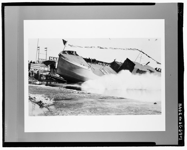 File:The finished hull of a 180 is launched in Duluth, Minnesota. Note the men holding onto the rail and riding the vessel during its launch. - U.S. Coast Guard Buoy Tenders, 180' Class, U.S. HAER DC-57-1.tif