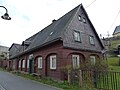 Residential house and wooden barn on a farm