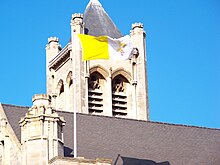 Flag of Vatican City flying atop the cathedral Vatican City Flag flying atop St Anne's Cathedral.jpg