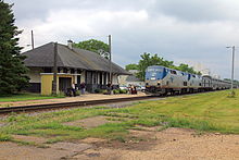 Tomah Amtrak Station with Empire Builder train Amtrak Empire Builder at Tomah, Wisconsin.jpg