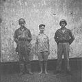 Men from the military police with a prisoner of war from the Republican Army, Banjoemas.