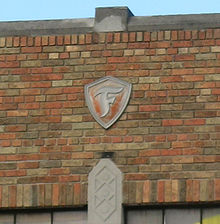Firestone badge atop John King (Carney-Labadie Building) Carney-Labadie Building detail - Detroit Michigan.jpg
