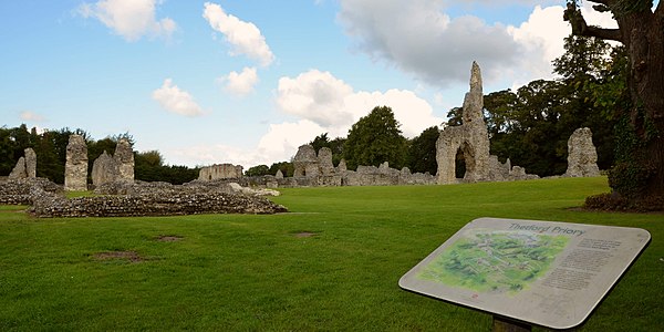 The remains of Thetford Priory with English Heritage information board in September 2017