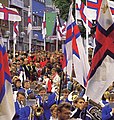 Faroese flags, brass band and sports people from Tórshavn at the Olavsoka Procession on 28 July.