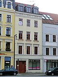 Residential house with shop in a closed development and workshop building in the courtyard