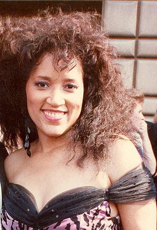 Among women large hair-dos and puffed-up styles typified the decade. (Jackee Harry, 1988) Jackee88.jpg