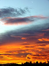 The crescent Moon remains visible just moments before sunrise. Moon in Sunrise Sky 2.jpg