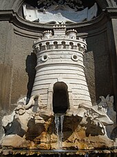 La fontana del palazzo comunale, scolpita nel travertino da Filippo Barigioni nel 1727. Raffigura lo stemma della città di Nepi: la torre con il serpente che si attorciglia ai suoi piedi