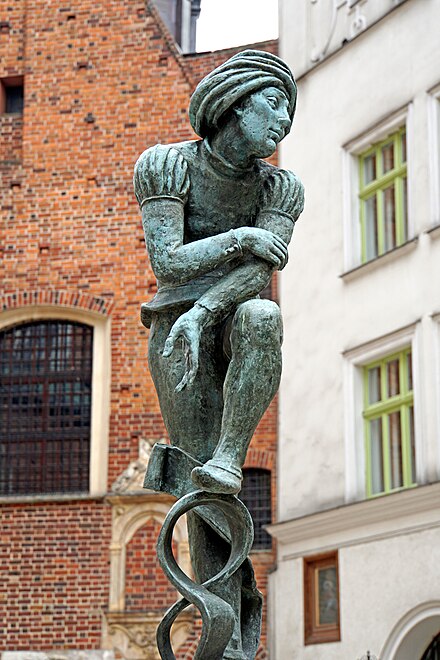 Figura żaka w Krakowie na placu Mariackim