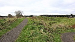 Trackbed looking towards the station. Railway embankment at the Wilsontown Ironworks Site, Lanarkshire, Scotland.jpg