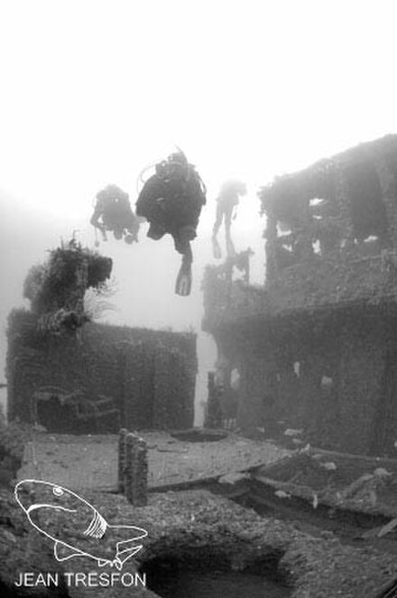 Divers over the deck forward of the wheelhouse of the MV Rockeater