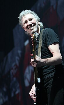 Roger Waters playing bass and singing.