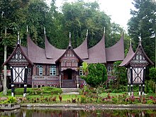 Two Minang rangkiang in front of Rumah Gadang, West Sumatra. Rumah Gadang.jpg