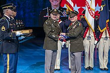 Funk is presented with his command flag by Army chief of staff General James C. McConville at his retirement ceremony on 9 September 2022. SGO Retirement Ceremony, Sept. 9, 2022, Gen. Paul E. Funk II (52353020825).jpg