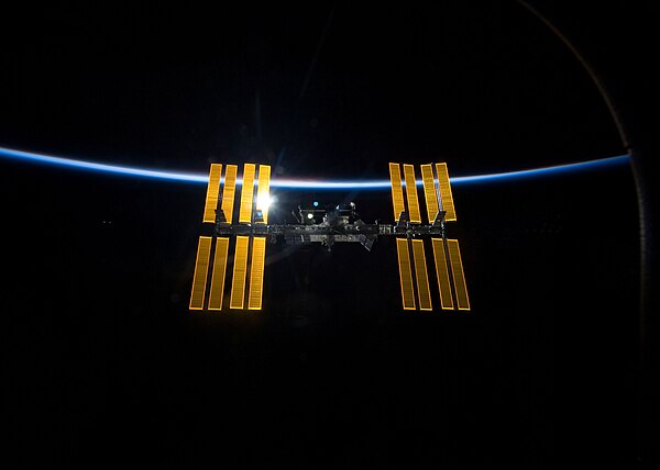 Departing view of the ISS from Discovery, with the station's fourth and final set of solar arrays installed