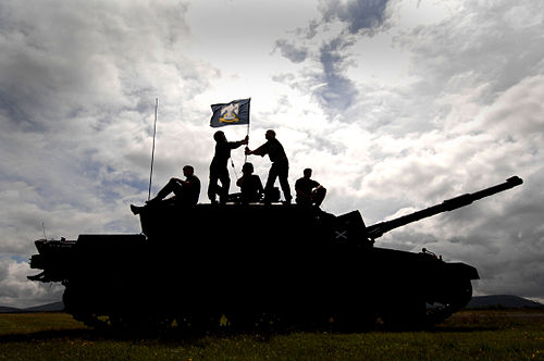The Royal Scots Dragoon Guards raise the regimental flag on their Challenger 2