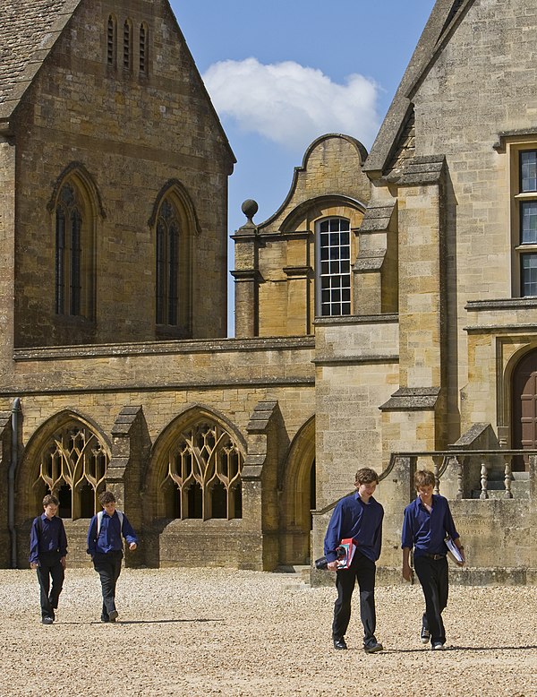 Sherborne boys in Blues walking across the Courts to classes