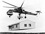 Sikorsky S-64 Skycrane lifting a prefab house