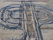 Skylink guideway above Terminal E (left) and Express South Parking Lot/future site of Terminal F (right)