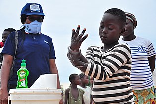 Supervising a young boy washing his hands Photo by User:Mayordeeliteman