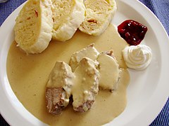 Image 19Svíčková na smetaně served with dumplings, whipped cream and cranberries (from Czech cuisine)